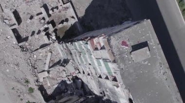 This stock vertical video shows the aftermath of the war in Ukraine - a destroyed residential building in Borodyanka, grey, flat video