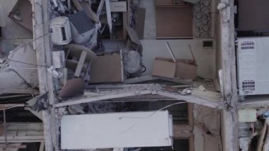 This stock vertical video shows the aftermath of the war in Ukraine - a destroyed residential building in Borodyanka, grey, flat video