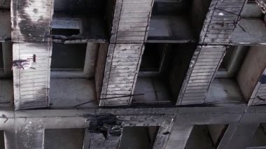 This stock vertical video shows the aftermath of the war in Ukraine - a destroyed residential building in Borodyanka, grey, flat video