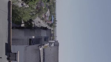 This stock vertical video shows the aftermath of the war in Ukraine - a destroyed residential building in Borodyanka, grey, flat video
