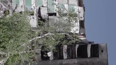 This stock vertical video shows the aftermath of the war in Ukraine - a destroyed residential building in Borodyanka, grey, flat video