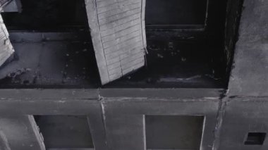 This stock vertical video shows the aftermath of the war in Ukraine - a destroyed residential building in Borodyanka, grey, flat video