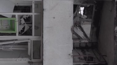 This stock vertical video shows the aftermath of the war in Ukraine - a destroyed residential building in Borodyanka, grey, flat video