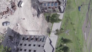 This stock vertical video shows the aftermath of the war in Ukraine - a destroyed residential building in Borodyanka, grey, flat video