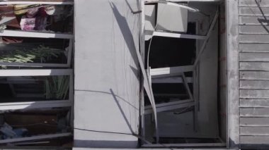 This stock vertical video shows the aftermath of the war in Ukraine - a destroyed residential building in Borodyanka, grey, flat video