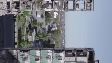 This stock vertical video shows the aftermath of the war in Ukraine - a destroyed residential building in Borodyanka, grey, flat video