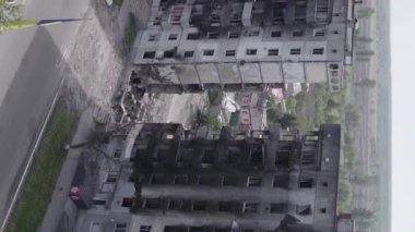 This stock vertical video shows the aftermath of the war in Ukraine - a destroyed residential building in Borodyanka, grey, flat video