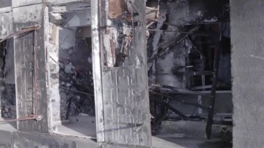 This stock vertical video shows the aftermath of the war in Ukraine - a destroyed residential building in Borodyanka, grey, flat video
