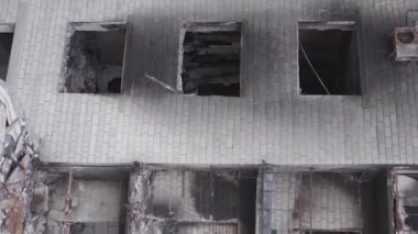 This stock vertical video shows the aftermath of the war in Ukraine - a destroyed residential building in Borodyanka, grey, flat video