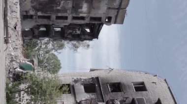This stock vertical video shows the aftermath of the war in Ukraine - a destroyed residential building in Borodyanka, grey, flat video