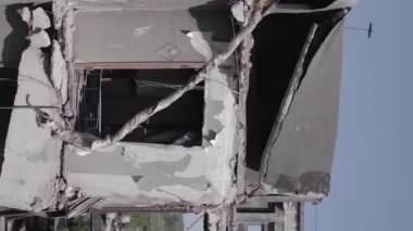 This stock vertical video shows the aftermath of the war in Ukraine - a destroyed residential building in Borodyanka, grey, flat video