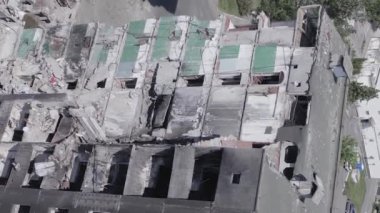 This stock vertical video shows the aftermath of the war in Ukraine - a destroyed residential building in Borodyanka, grey, flat video