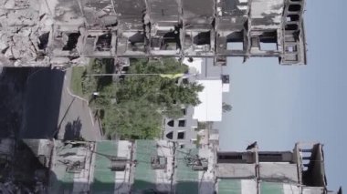 This stock vertical video shows the aftermath of the war in Ukraine - a destroyed residential building in Borodyanka, grey, flat video