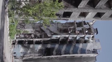 This stock vertical video shows the aftermath of the war in Ukraine - a destroyed residential building in Borodyanka, grey, flat video