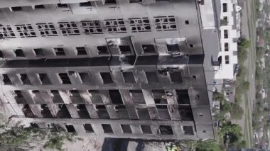 This stock vertical video shows the aftermath of the war in Ukraine - a destroyed residential building in Borodyanka, grey, flat video