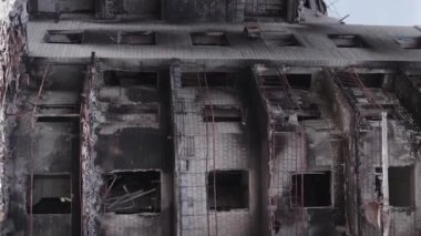 This stock vertical video shows the aftermath of the war in Ukraine - a destroyed residential building in Borodyanka, grey, flat video