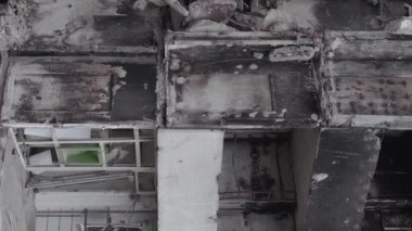 This stock vertical video shows the aftermath of the war in Ukraine - a destroyed residential building in Borodyanka, grey, flat video