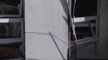 This stock vertical video shows the aftermath of the war in Ukraine - a destroyed residential building in Borodyanka, grey, flat video