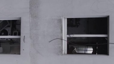 This stock vertical video shows the aftermath of the war in Ukraine - a destroyed residential building in Borodyanka, grey, flat video