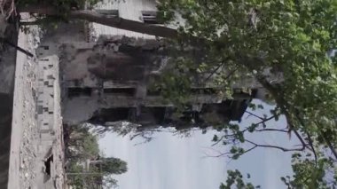 This stock vertical video shows the aftermath of the war in Ukraine - a destroyed residential building in Borodyanka, grey, flat video