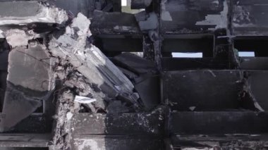 This stock vertical video shows the aftermath of the war in Ukraine - a destroyed residential building in Borodyanka, grey, flat video