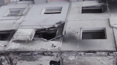 This stock vertical video shows the aftermath of the war in Ukraine - a destroyed residential building in Borodyanka, grey, flat video