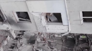 This stock vertical video shows the aftermath of the war in Ukraine - a destroyed residential building in Borodyanka, grey, flat video