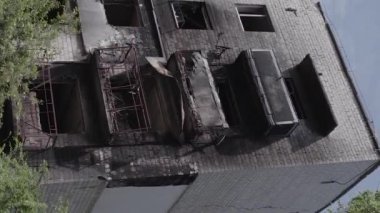 This stock vertical video shows the aftermath of the war in Ukraine - a destroyed residential building in Borodyanka, grey, flat video