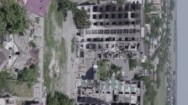 This stock vertical video shows the aftermath of the war in Ukraine - a destroyed residential building in Borodyanka, grey, flat video