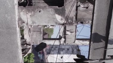 This stock vertical video shows the aftermath of the war in Ukraine - a destroyed residential building in Borodyanka, grey, flat video