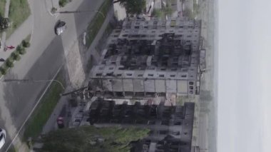 This stock vertical video shows the aftermath of the war in Ukraine - a destroyed residential building in Borodyanka, grey, flat video
