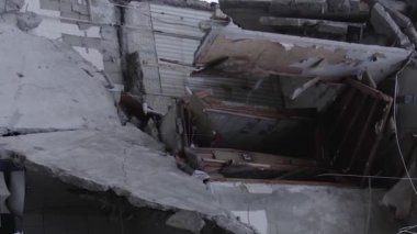 This stock vertical video shows the aftermath of the war in Ukraine - a destroyed residential building in Borodyanka, grey, flat video