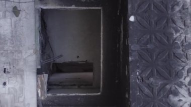 This stock vertical video shows the aftermath of the war in Ukraine - a destroyed residential building in Borodyanka, grey, flat video