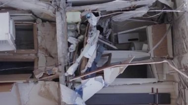 This stock vertical video shows the aftermath of the war in Ukraine - a destroyed residential building in Borodyanka, grey, flat video