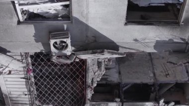 This stock vertical video shows the aftermath of the war in Ukraine - a destroyed residential building in Borodyanka, grey, flat video