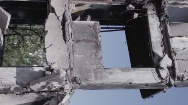 This stock vertical video shows the aftermath of the war in Ukraine - a destroyed residential building in Borodyanka, grey, flat video