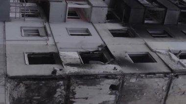 This stock vertical video shows the aftermath of the war in Ukraine - a destroyed residential building in Borodyanka, grey, flat video