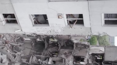 This stock vertical video shows the aftermath of the war in Ukraine - a destroyed residential building in Borodyanka, grey, flat video