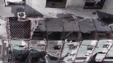 This stock vertical video shows the aftermath of the war in Ukraine - a destroyed residential building in Borodyanka, grey, flat video