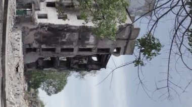 This stock vertical video shows the aftermath of the war in Ukraine - a destroyed residential building in Borodyanka, grey, flat video