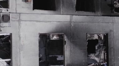 This stock vertical video shows the aftermath of the war in Ukraine - a destroyed residential building in Borodyanka, grey, flat video