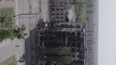 This stock vertical video shows the aftermath of the war in Ukraine - a destroyed residential building in Borodyanka, grey, flat video