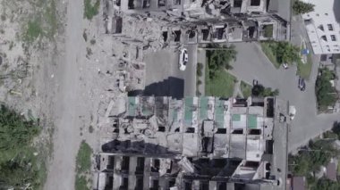 This stock vertical video shows the aftermath of the war in Ukraine - a destroyed residential building in Borodyanka, grey, flat video