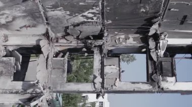 This stock vertical video shows the aftermath of the war in Ukraine - a destroyed residential building in Borodyanka, grey, flat video