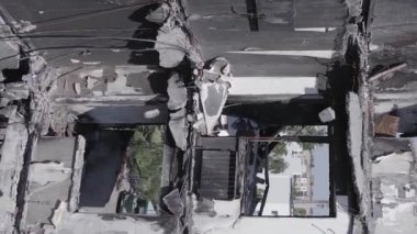 This stock vertical video shows the aftermath of the war in Ukraine - a destroyed residential building in Borodyanka, grey, flat video