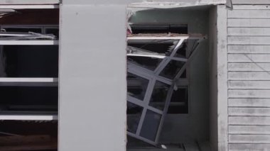 This stock vertical video shows the aftermath of the war in Ukraine - a destroyed residential building in Borodyanka, grey, flat video
