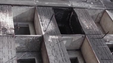 This stock vertical video shows the aftermath of the war in Ukraine - a destroyed residential building in Borodyanka, grey, flat video
