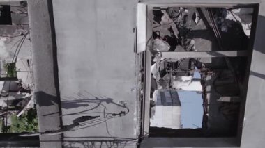 This stock vertical video shows the aftermath of the war in Ukraine - a destroyed residential building in Borodyanka, grey, flat video