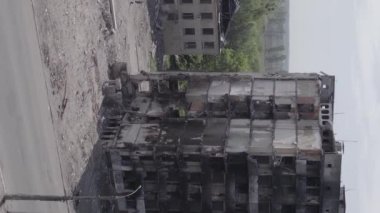 This stock vertical video shows the aftermath of the war in Ukraine - a destroyed residential building in Borodyanka, grey, flat video