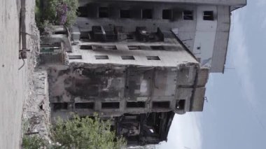 This stock vertical video shows the aftermath of the war in Ukraine - a destroyed residential building in Borodyanka, grey, flat video